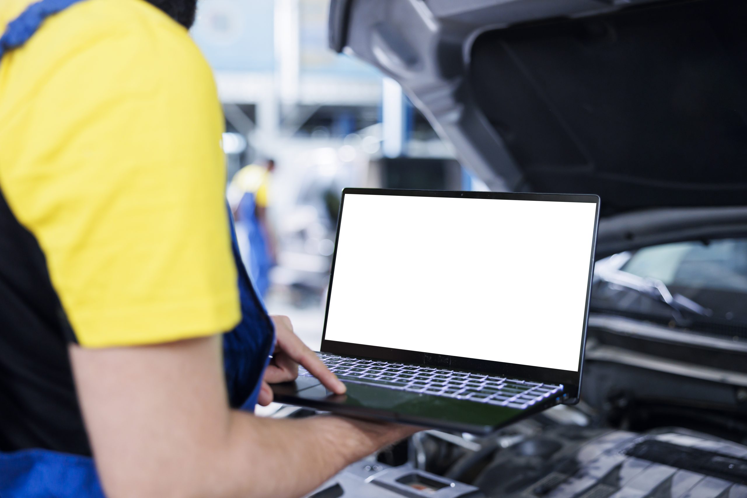 Employee checks car with mockup laptop
